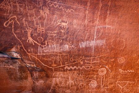 Native American petroglyphs - art drawings, estimated to be over 4000 years old, at Atlatl Rock, Valley of Fire State Park, Nevada, USAの写真素材