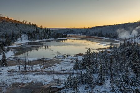 Steaming vents and lake along a road in Yellowstone National Park, Wyoming, USAの写真素材
