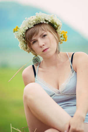 Pretty farm lady sitting on a haystackの写真素材