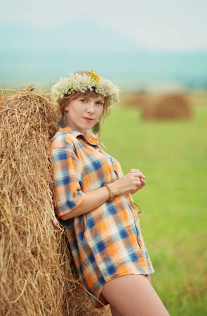 Pretty farm lady near a haystackの写真素材
