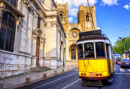 Historical yellow tram in front of the Lisbon cathedral, Alfama, Lisbon, Portugalのeditorial素材