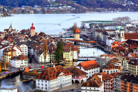 Aerial view of the red tiled roofs of the old town of Lucerne, wooden Chapel bridge, stone Water tower, Reuss river and Lake Lucerne, Switzerlandの写真素材