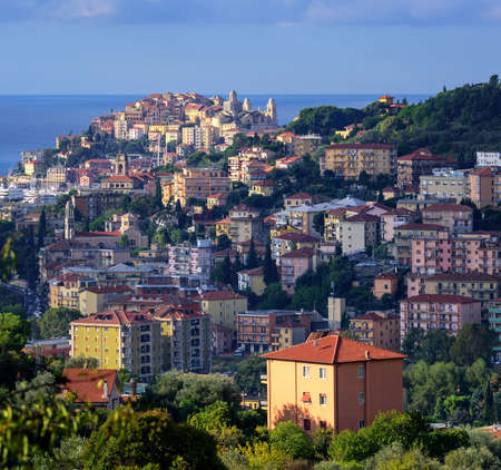 Old town of Imperia on the green hills of Maritime Alps mountains on italian Riviera, Liguria, Italyの写真素材