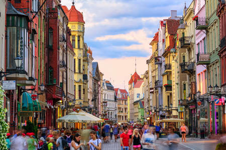 Torun, Poland - July 06: Crowded pedestrian street on a summer evening in the old town of Torun...