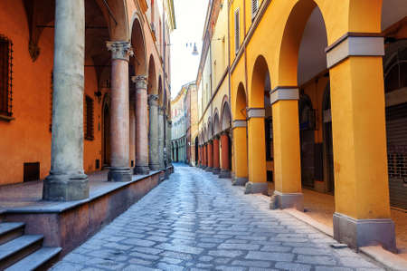 Historical arcade street in the old town of Bologna, Italy