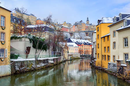 Old Town of Luxembourg and the Grund reflecting in water of Petrusse river on a snow winter dayのeditorial素材