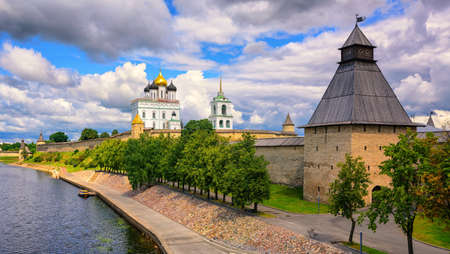The watch tower, the walls and golden dome of Trinity Church in Pskov Kremlin on Velikaya river, Pskov, Russiaの写真素材