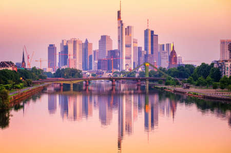 Frankfurt financial district skyscrapers reflecting in Main river, Germany, on sunsetの写真素材