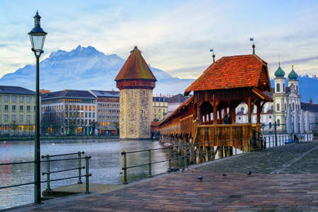 Chapel Bridge, Water Tower and Mount Pilatus in the old town of Lucerne, Switzerland, in the early morning lightの写真素材