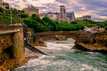 Biarritz city, view of the atlantic coast and Cathedral, France, on dramatic sunsetの写真素材
