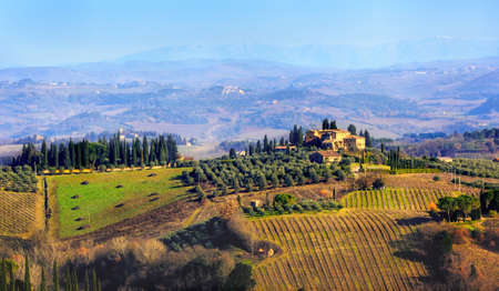 Tuscany, Italy - Januar 04: Scenic landscape with hills, olive groves and cypress alleys are...