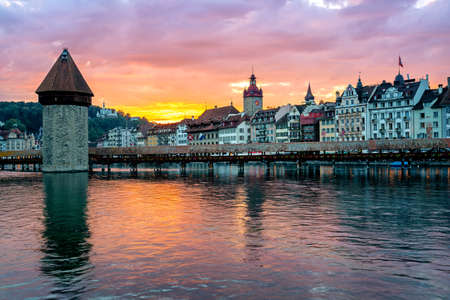 Lucerne, Switzerland, wooden Chapel bridge and medieval Old Town in dramatic sunset lightの写真素材