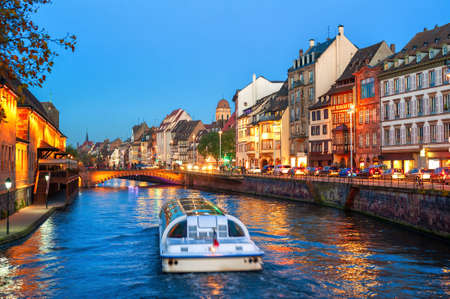 A touristic boat on a historical canal in Strasbourg Old town, Alsace, France