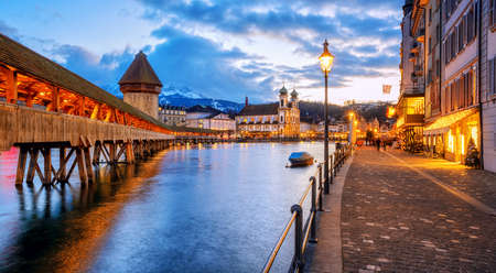 Lucerne Old town center with view of wooden Chapel bridge, Water tower, Mount Pilatus and riverside promenade, Switzerlandの写真素材