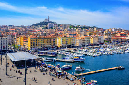 The old harbour Vieux Port and Basilica Notre Dame de la Garde in the historical city center of Marseilles, Franceの写真素材