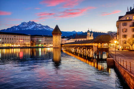 Historical wooden Chapel bridge and Mount Pilatus in Lucerne Old town, Switzerland, in dramatic...