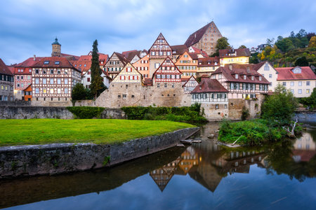 Gothic half-timbered houses reflecting in blue river in the Schwabisch Hall city Old town, Germanyの写真素材