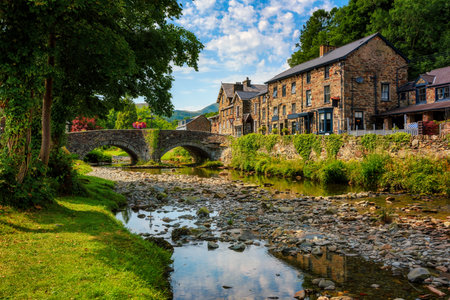 Traditional stone houses and bridge in historical mountain village Beddgelert in Snowdonia region of  North Wales, United Kingdomの写真素材