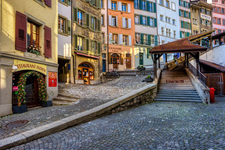 Lausanne, Switzerland - 12 April 2021: Picturesque Escaliers du Marche covered staircase in the Old town center is one of the main landmarks in Lausanne city, Switzerlandのeditorial素材