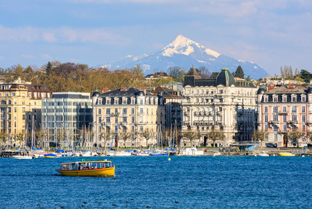Geneva city on Lake Geneva, Switzerland, view of the beautiful historical lakeside houses and snow covered Alps mountain peakのeditorial素材