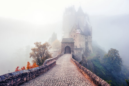 Historical Burg Eltz castle, Moselle river valley, Germany, in a cloud of mist on a cold autumn dayのeditorial素材