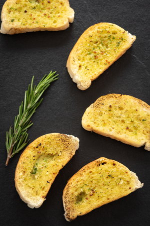 Crunchy garlic bread on dark backgroundの写真素材
