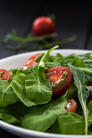 Tomato salad on white plateの写真素材