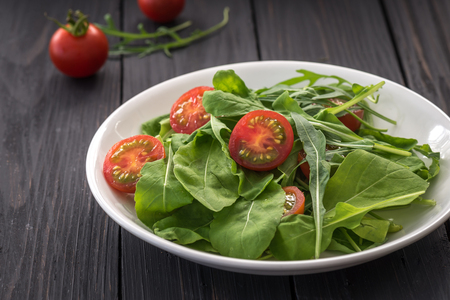 Tomato salad on white plateの写真素材