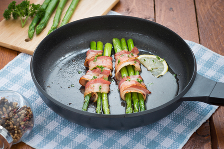 Fresh Young Asparagus Wrapped in Prosciutto Meat and Grilledの写真素材