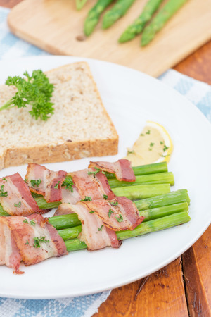 Fresh Young Asparagus Wrapped in Prosciutto Meat and Grilledの写真素材