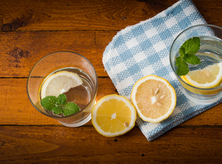 Lemonade with fresh lemon on wooden backgroundの写真素材