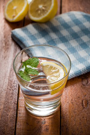 Lemonade with fresh lemon on wooden backgroundの写真素材