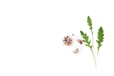 Space vegetable rocket salad with garlic and pepper on isolated white backgroundの写真素材