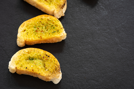 Crunchy garlic bread on dark backgroundの写真素材