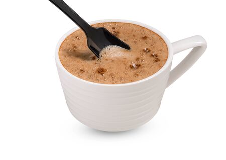 coffee in white cup with black spoon on white backgroundの写真素材