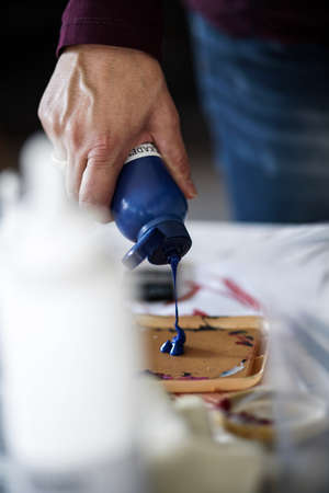 Artist preparing paint for her work. High quality photo