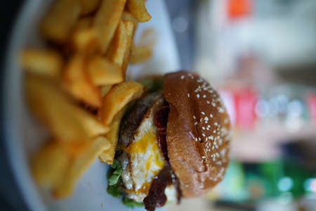 Burger with barbecue sauce eggs and fries.High quality photoの写真素材