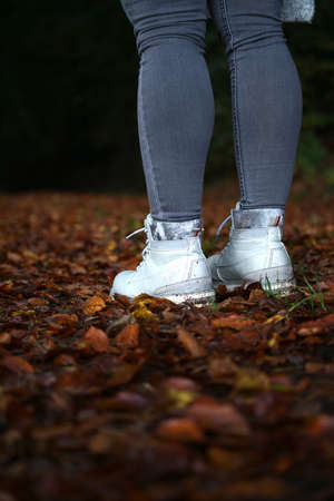 Standing on fallen leafs with boots autum vibes. High quality photoの写真素材