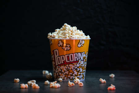 A bucket full of popcorn black backgroundの写真素材