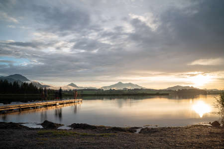 Sunset at a lake with a bridge in itの写真素材