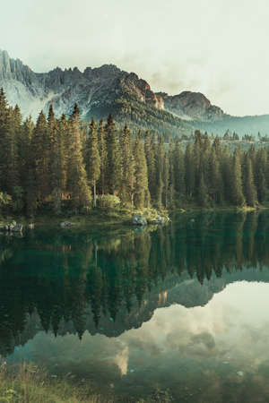 Mountains reflect in the water of the lakeの写真素材