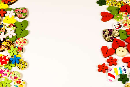 Multicolored wooden sewing buttons on white backgroundの写真素材