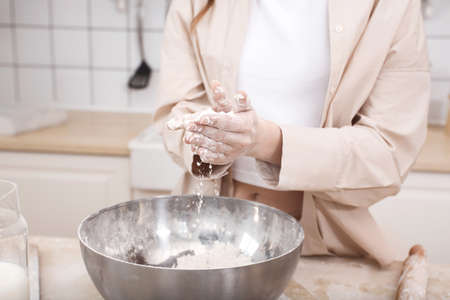 Womens hands kneading dough for bakingの写真素材