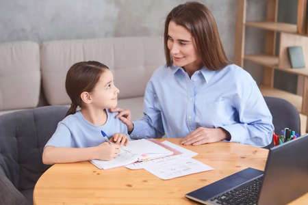 teacher with student doing online lessons, online education concept, online learning with kids at homeの写真素材