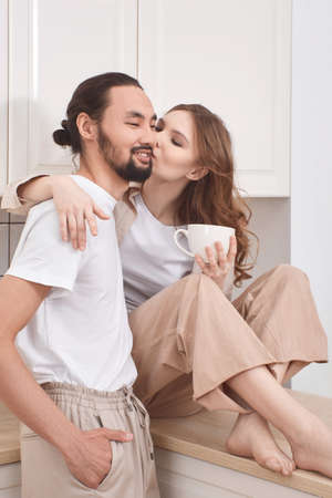 Couple in love having breakfast in the kitchen, multinationalityの写真素材
