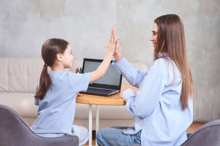 teacher with student doing online lessons, online education concept, online learning with kids at homeの写真素材