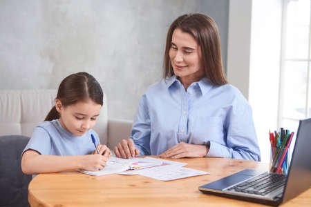 teacher with student doing online lessons, online education concept, online learning with kids at homeの写真素材