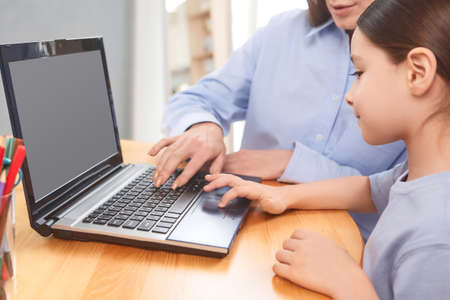 teacher with student doing online lessons, online education concept, online learning with kids at homeの写真素材