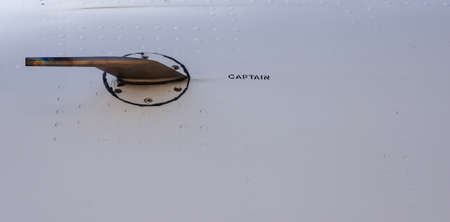Close up of the nose of an commercial aircraft, with the word captain written on it.