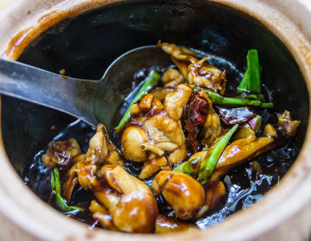 claypot Frog Legs with Green Spring Onions in Brown Sauceの写真素材